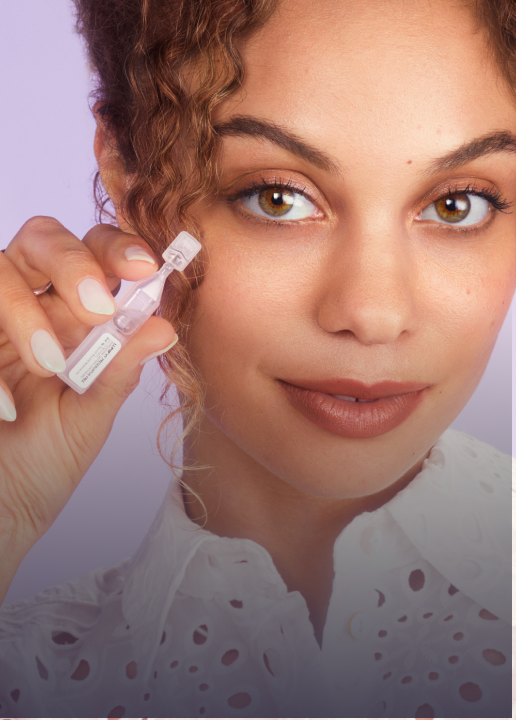 Woman holding Lumify redness reliever eye drops